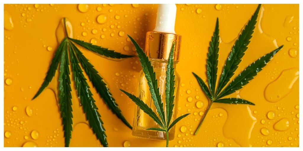 Cannabis oil on a wet yellow background.