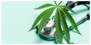 cannabis leaf and stethoscope on a light blue surface
